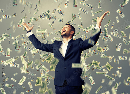 Bild auf Leinwand man standing under dollar's rain