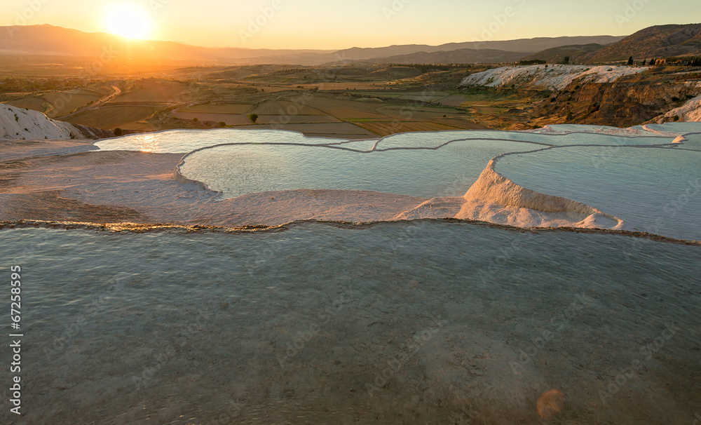 Carbonate travertines with blue water, Pamukkale, at sunset