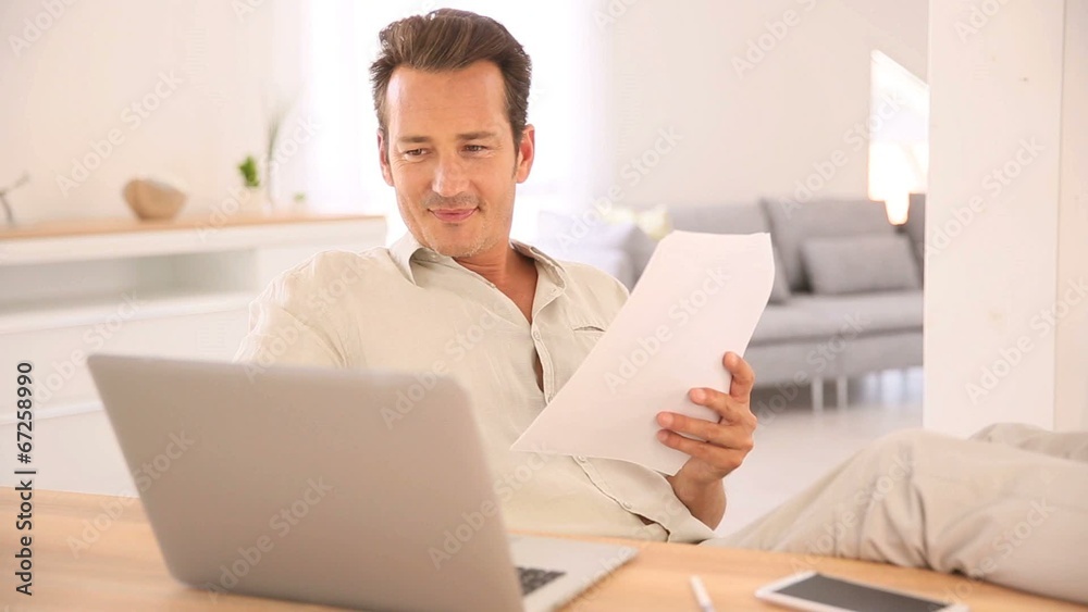 Man at home working on laptop computer