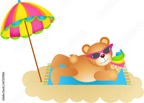 Teddy bear soaking up the sun on a beach © soniagoncalves