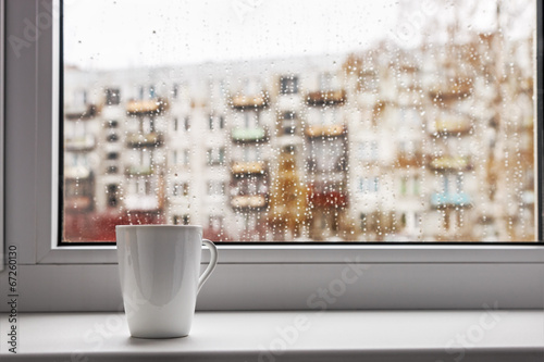 cup of hot coffee on the window