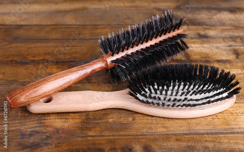 Photos Wooden hairbrushes on wooden background