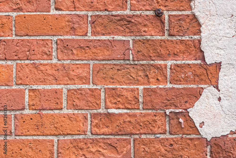 Obraz premium Very old brick exterior wall with stucco