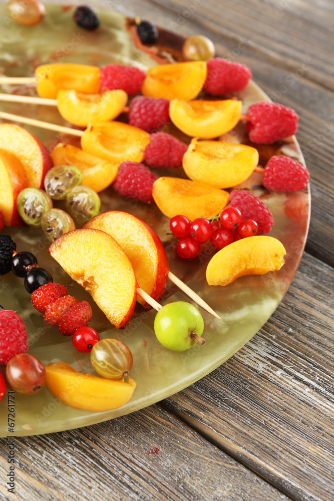 Fresh fruit skewers for healthy snack on wooden table close up Fresh fruit skewers for healthy snack on wooden table close up