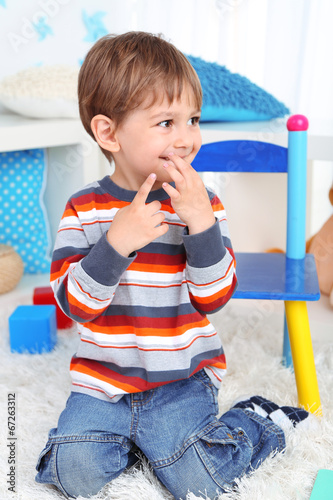 Cute little boy in room