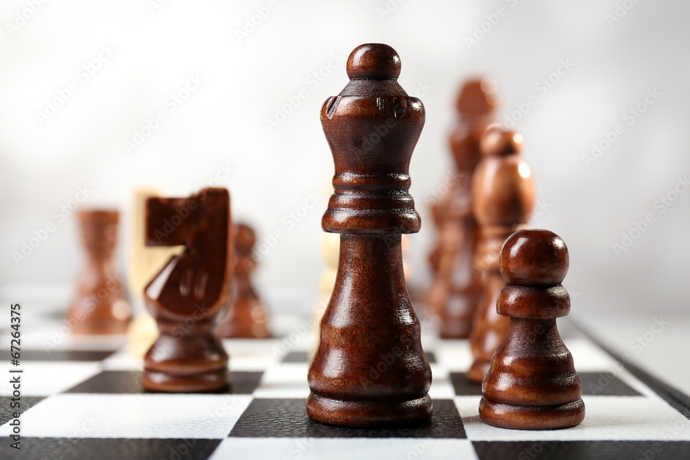 Chess board with chess pieces on grey background Chess board with chess pieces on grey background
