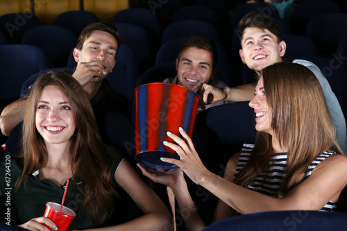 Young people watching movie in cinema