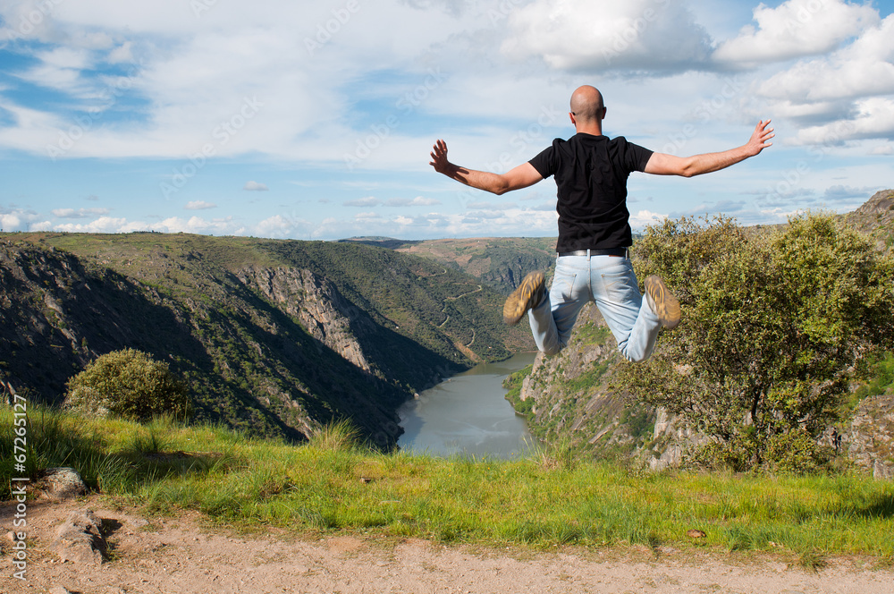Fototapeta premium Young man jumping. Arribes del Duero river natural park