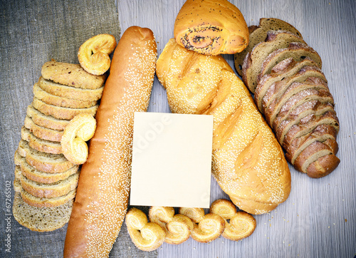 Fresh Tasty Bread on Woody Background.