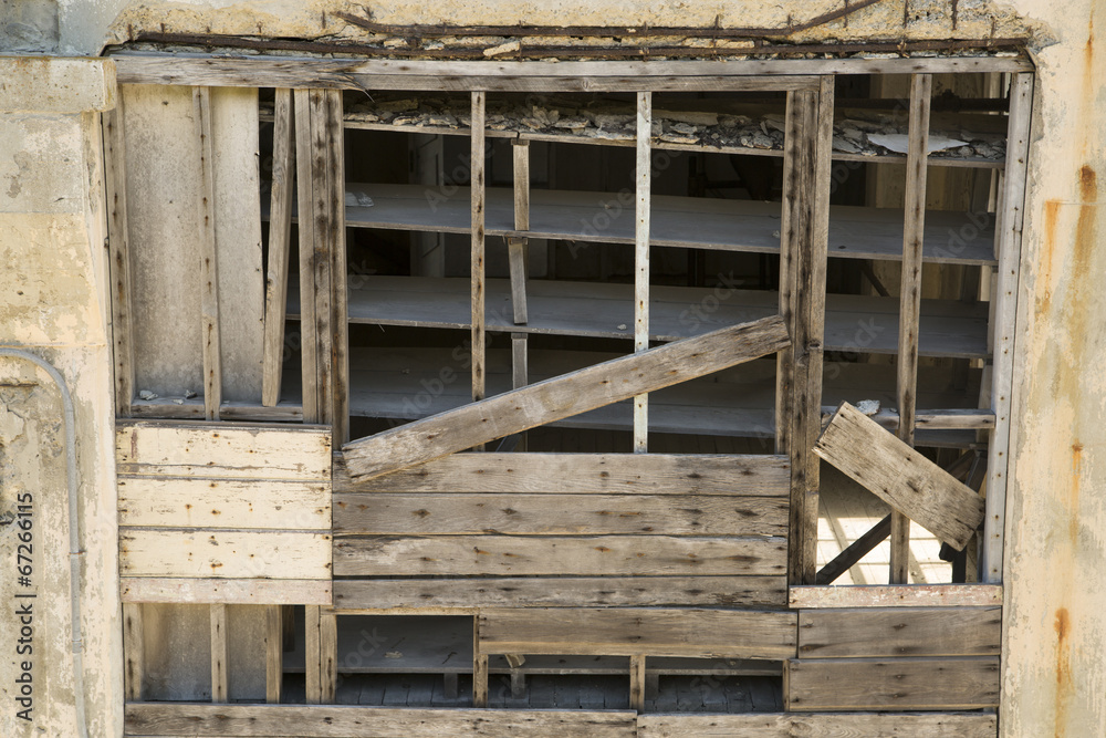old rundown warehouse wall built of wood and cement old rundown warehouse wall built of wood and cement