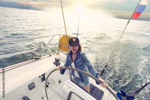 Woman steering yacht b