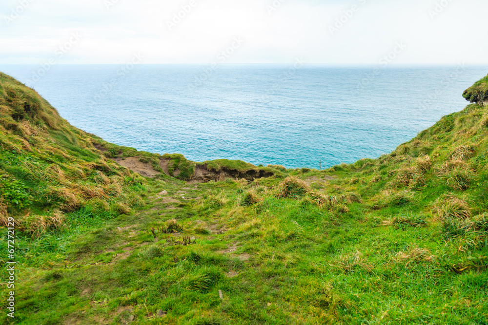 Alantic ocean and field of green grass, Ireland Europe Alantic ocean and field of green grass, Ireland Europe