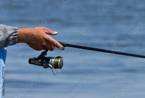 Fishing rod over the blue water