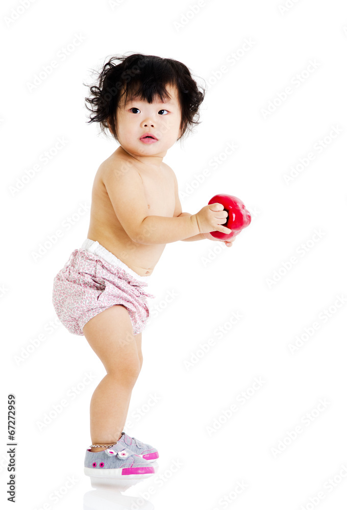 healthy baby holding a capsicum. healthy eating concept. healthy baby holding a capsicum. healthy eating concept.
