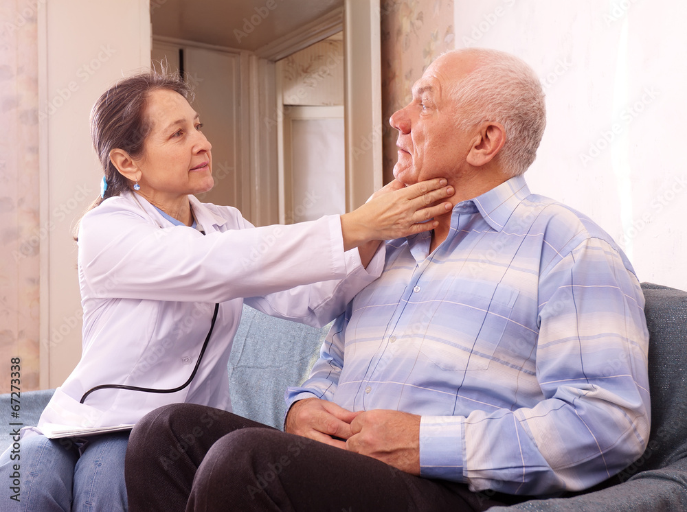 Fototapeta premium mature doctor examining senior man
