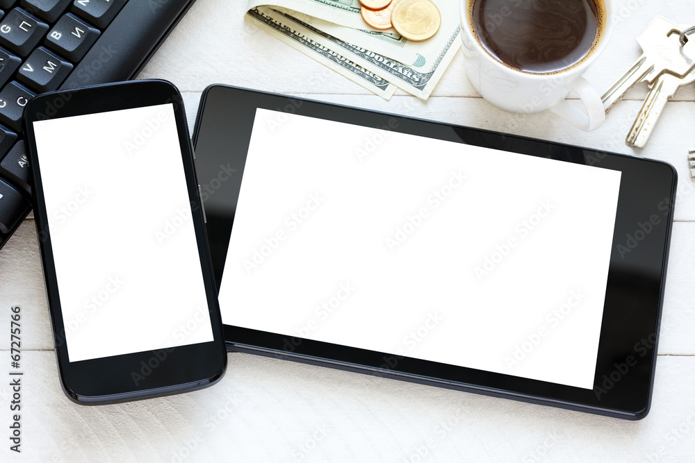 Tablet and smartphone with white blank screen on wooden table Tablet and smartphone with white blank screen on wooden table