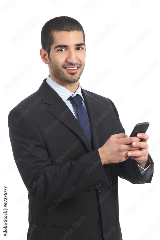 Arab businessman using a smartphone and looking at camera Arab businessman using a smartphone and looking at camera