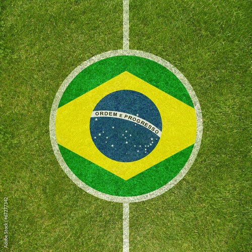 Football field center closeup with Brazilian flag in circle