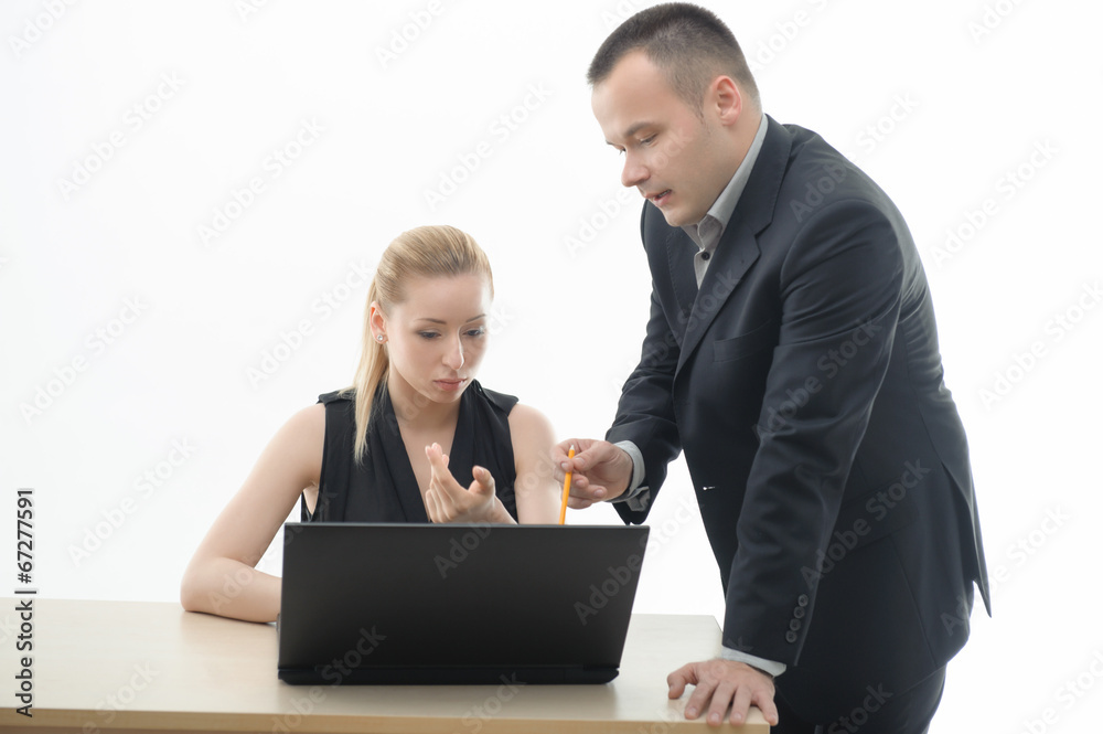 Colleagues discussing something sitting by computer Colleagues discussing something sitting by computer