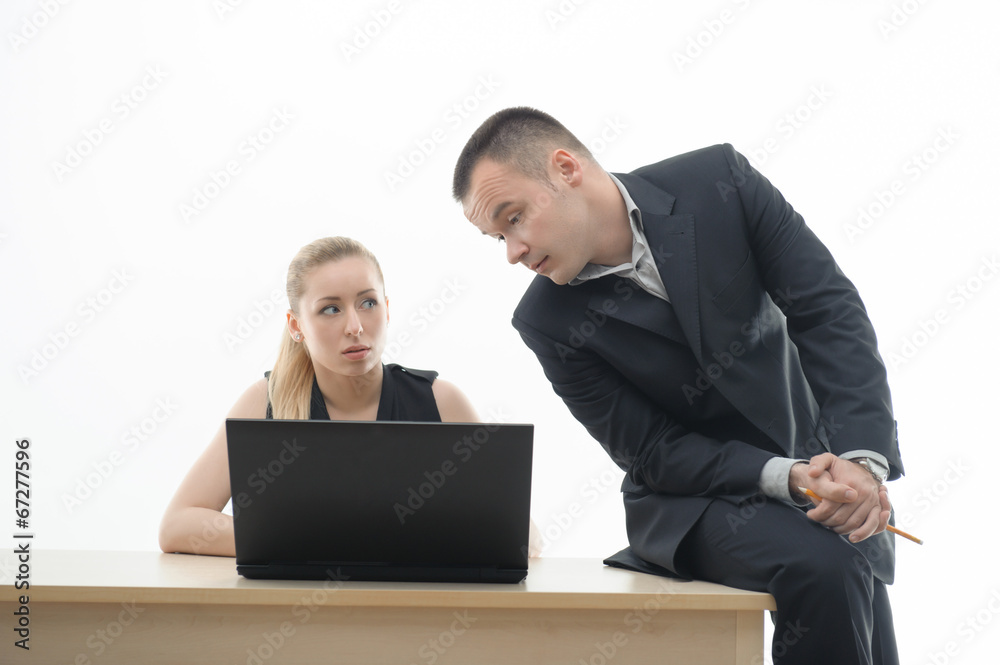 Colleagues discussing something sitting by computer Colleagues discussing something sitting by computer