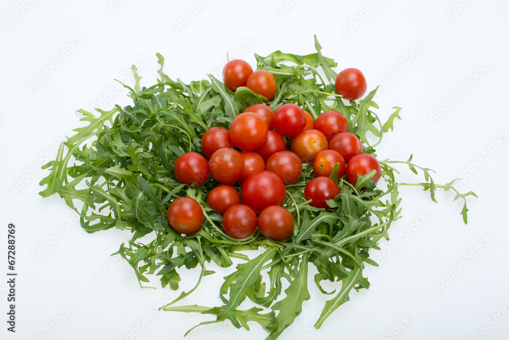 Heap of ruccola leaves and cherry tomatoes Heap of ruccola leaves and cherry tomatoes