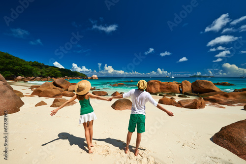 Couple in green on a beach at Seychelles