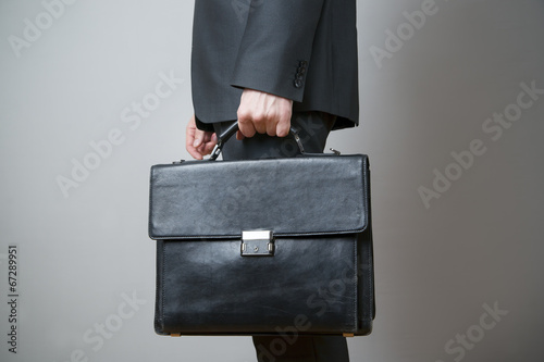 Businessman with briefcase in hand photo