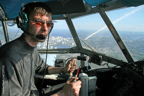 Young pilot in the cockpit aircraft during flight