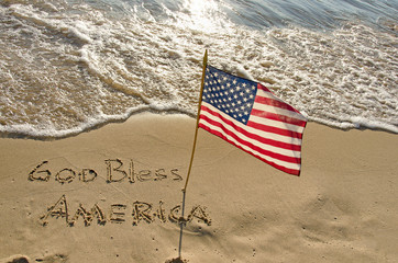 American flag in beach sand