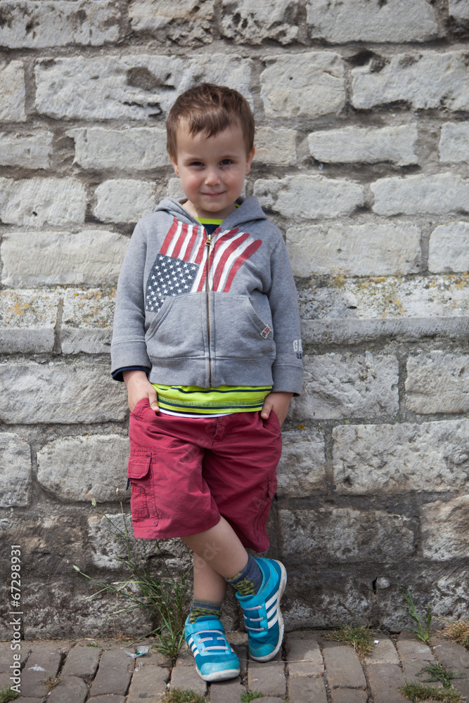 cute boy in front of wall