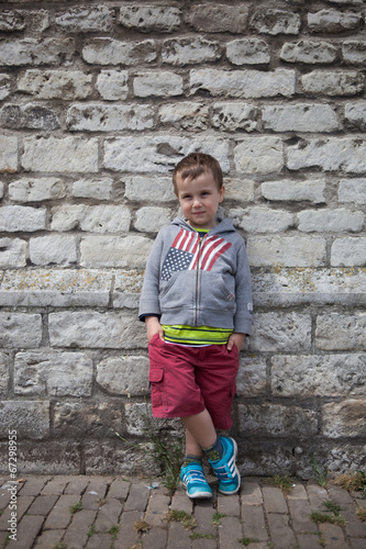 cute boy in front of wall