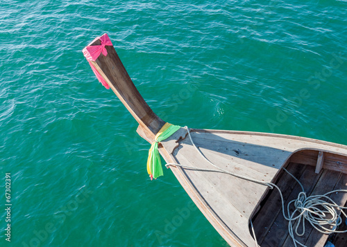 top view of wooden boat sailing on blue sea in Thailand