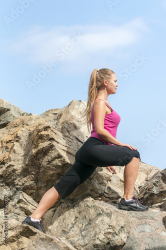 Fitness. Young woman training on a mountain © Nina Nagovitsina