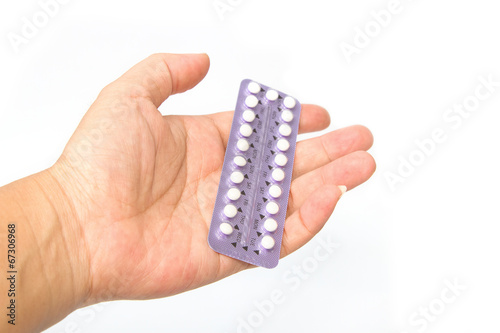  young woman's hand holding birth control pills