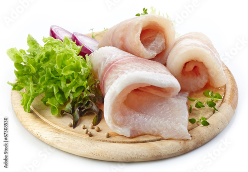 Sticker raw fish fillets on wooden cutting board
