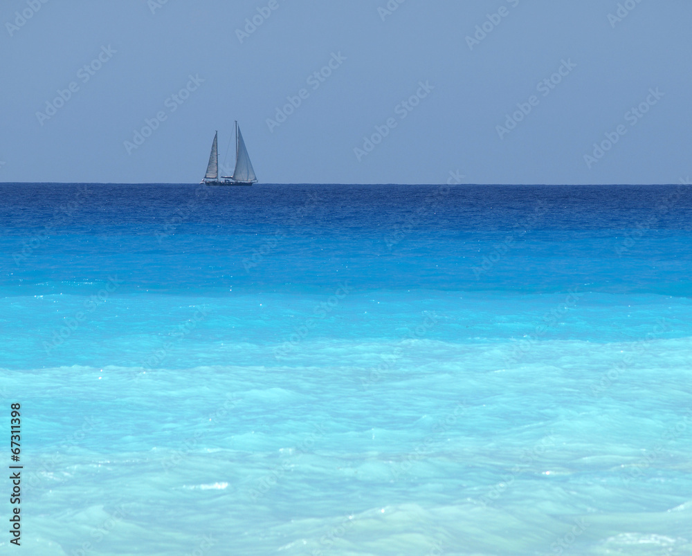 sailboat with a white sail, blue Mediterranean sea