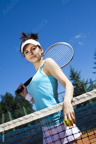 Young woman tennis player on the court 