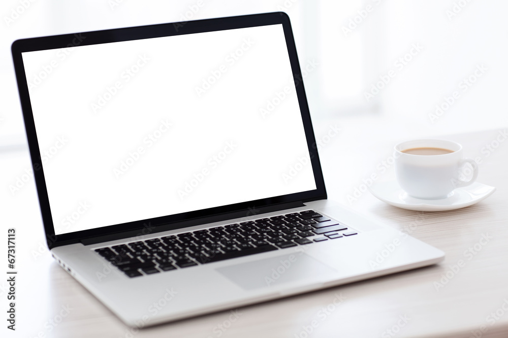laptop computer with isolated screen is on the table in a white laptop computer with isolated screen is on the table in a white