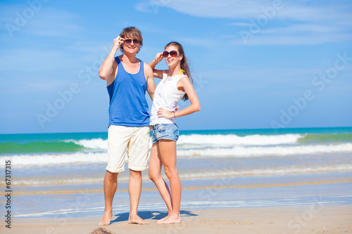 young couple hugging and looking at the sun at tropical beach © el.rudakova