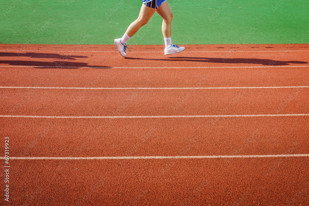 An athlete is running on racetrack
