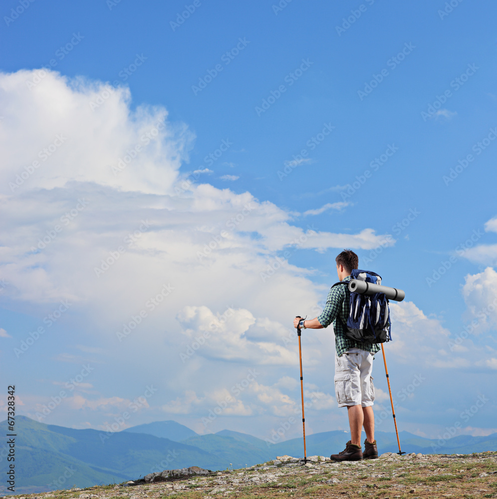 Male hiker standing on a mountain top