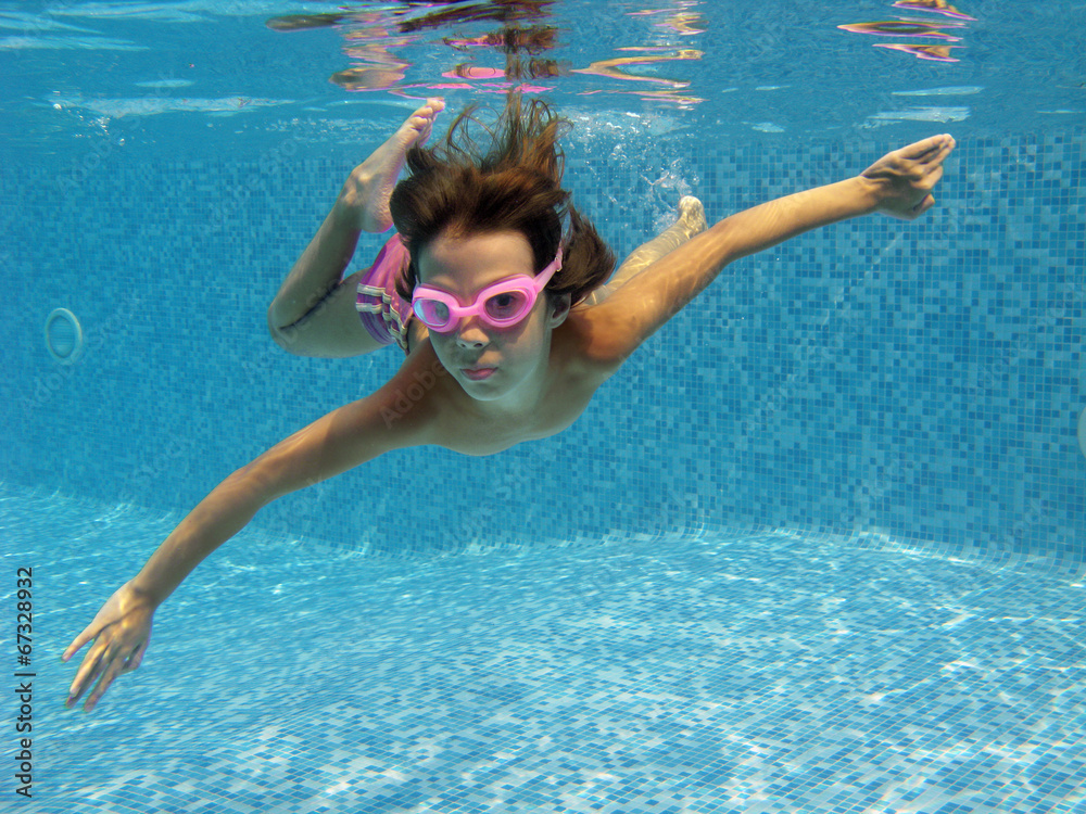 Fototapeta premium Happy active underwater child swims in pool, kids sport