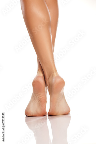 beautiful women's feet and legs on white background