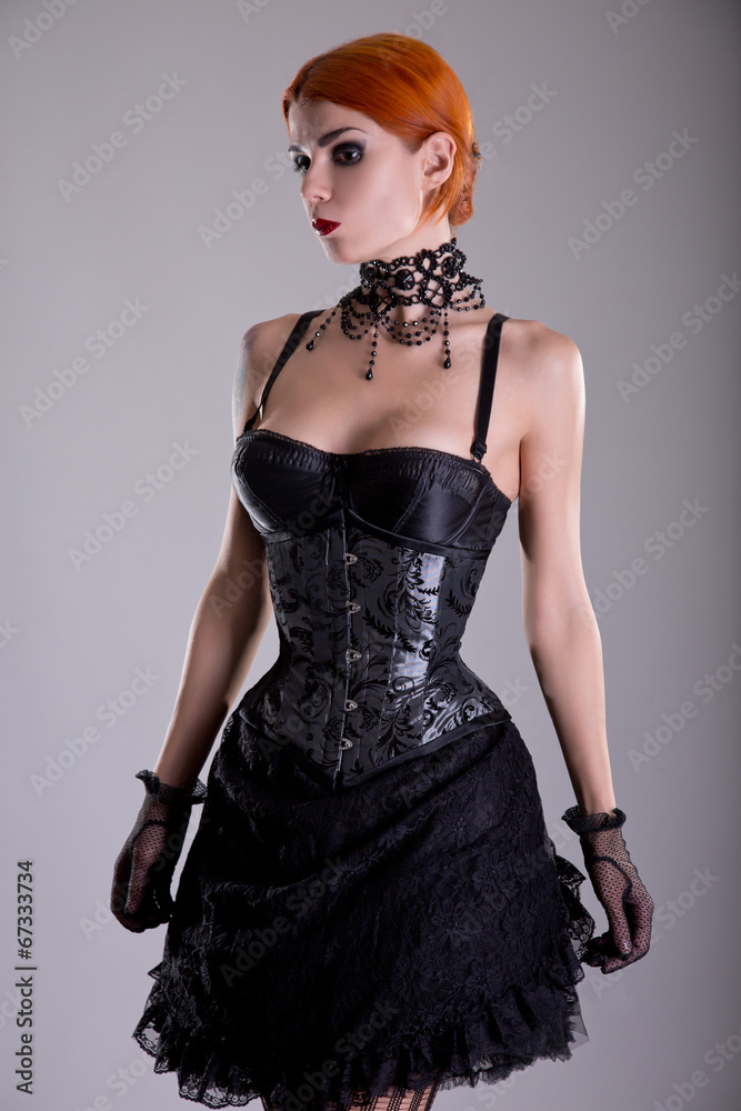 Pretty redhead young woman in silver corset and black skirt Pretty redhead young woman in silver corset and black skirt