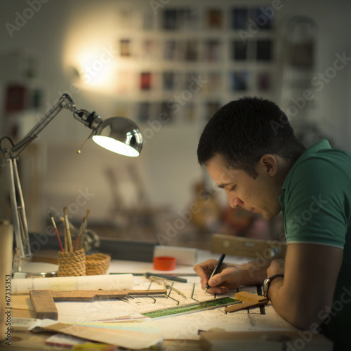 Architect Working On Blueprint - Late night worker