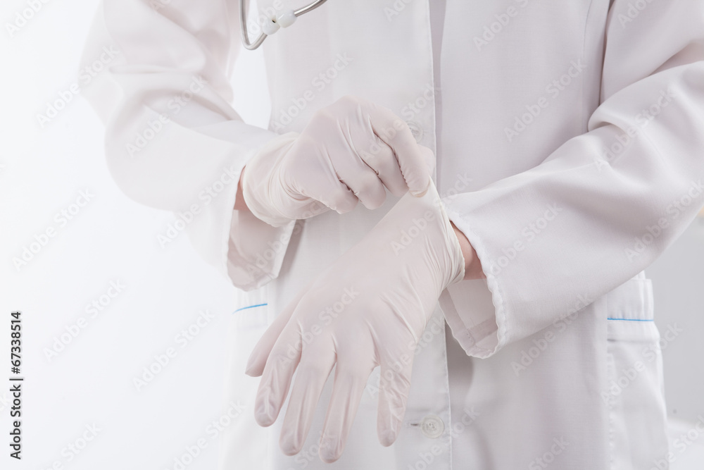 Doctor putting on protective gloves Doctor putting on protective gloves