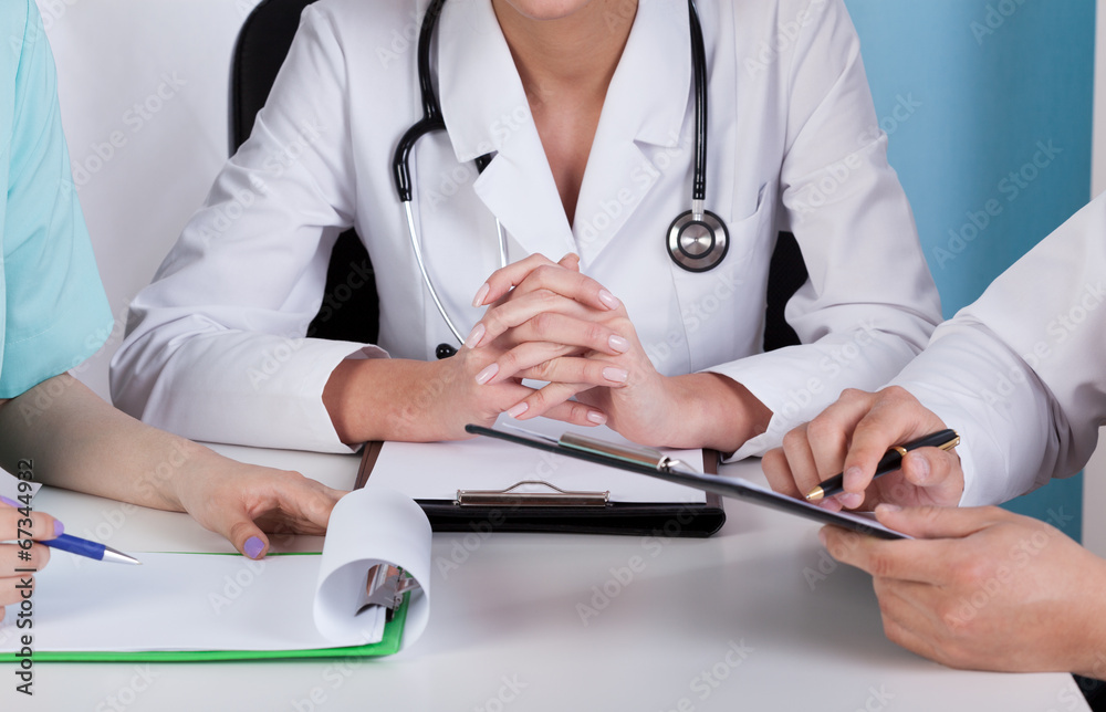 Hands of doctors with clipboards Hands of doctors with clipboards