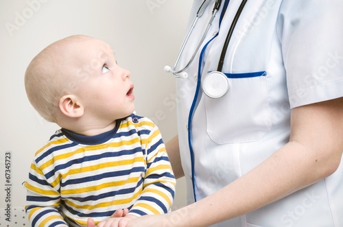 Baby looking at doctor