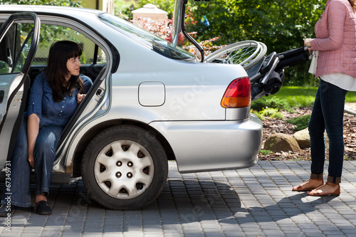 Girl taking wheelchair from car