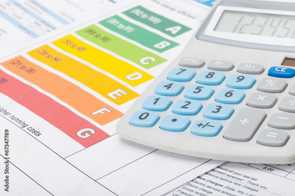 Energy efficiency chart with calculator - studio shot Energy efficiency chart with calculator - studio shot